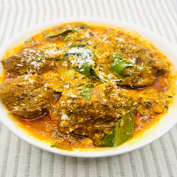 Himalayan Spice Indian Cuisine's flavorful curry dish, garnished with fresh herbs and spices.